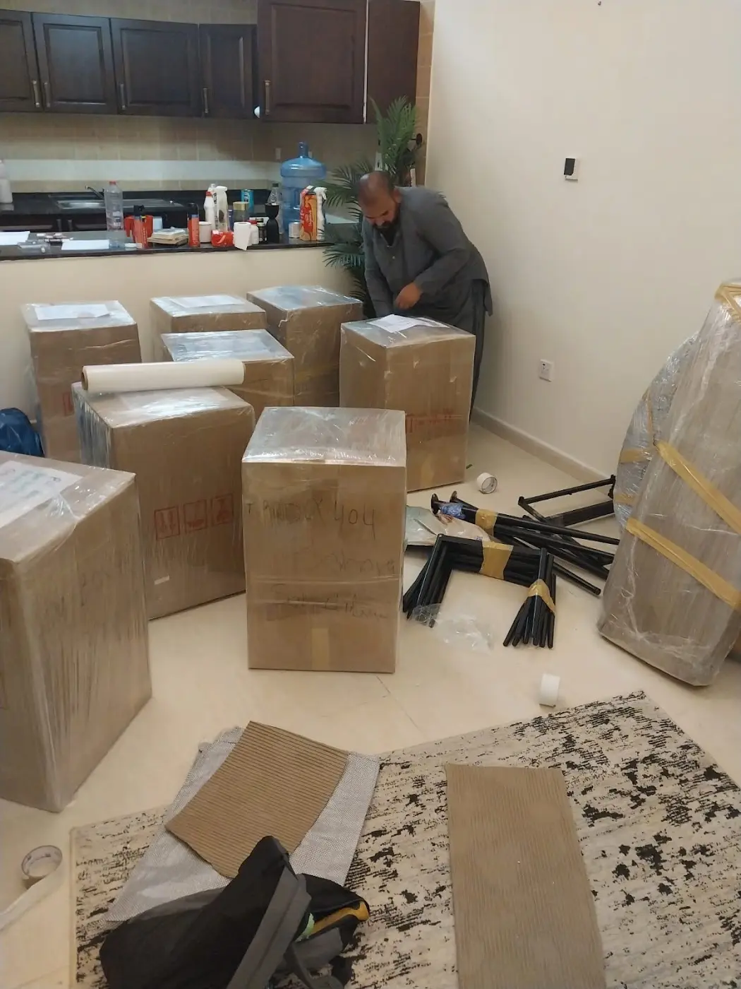 Packed cartons and dismantled furniture in an apartment