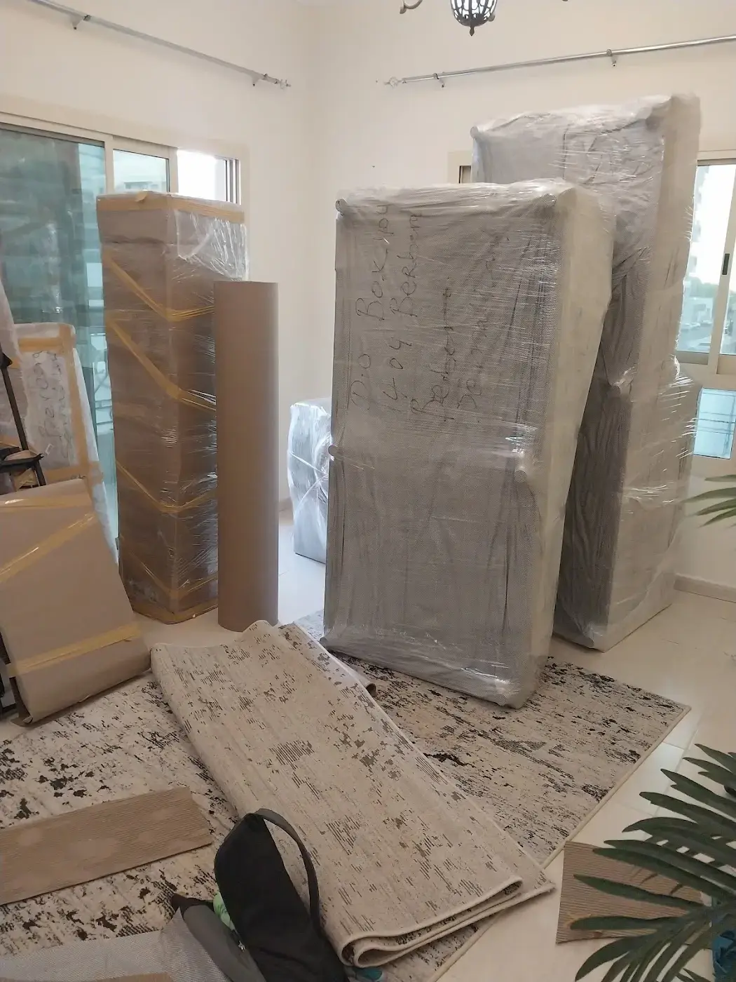 Mattresses sealed in plastic and rugs rolled